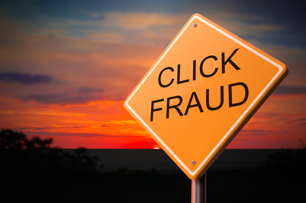 Click Fraud on Warning Road Sign on Sunset Sky Background.