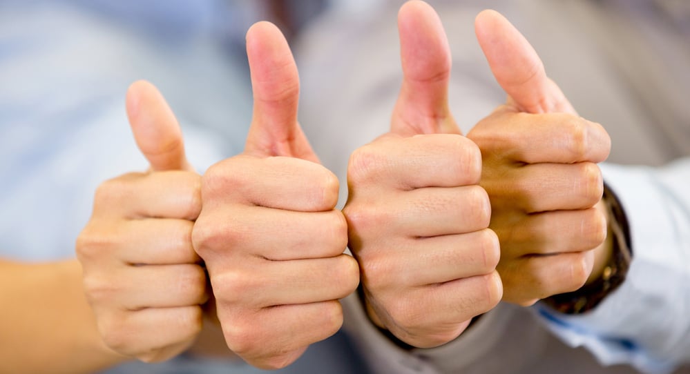 Group of hands with thumbs up expressing positivity