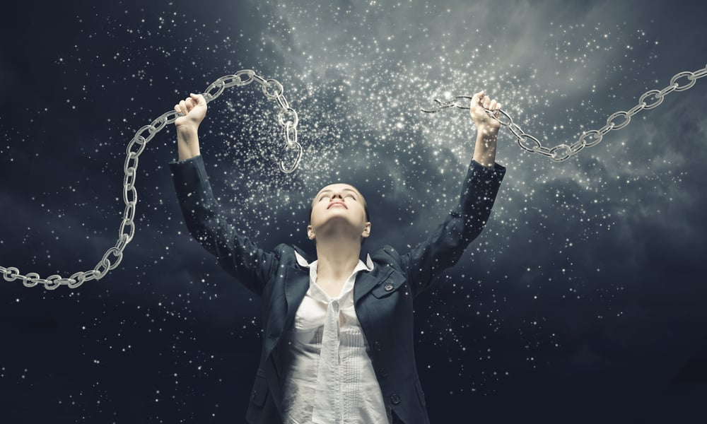 Image of businesswoman in anger breaking metal chain